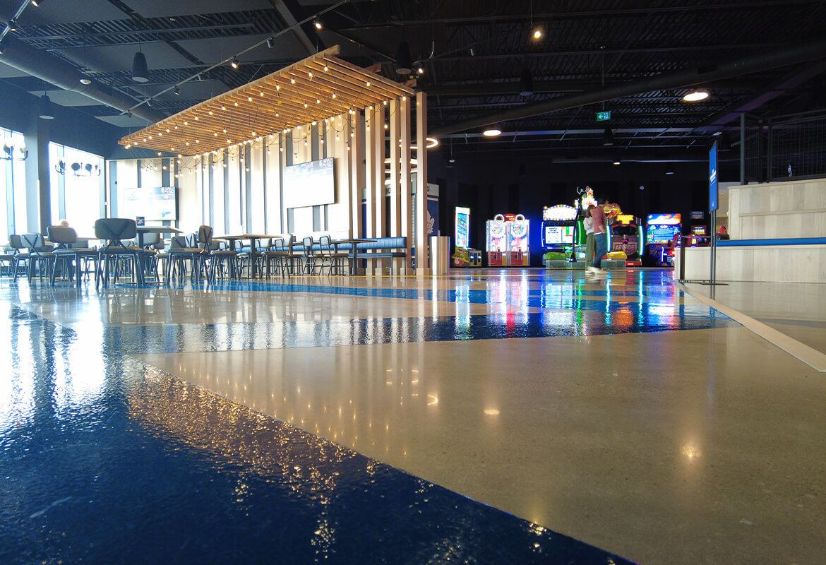 Polished concrete flooring in Cineplex junxion dining and arcade area.